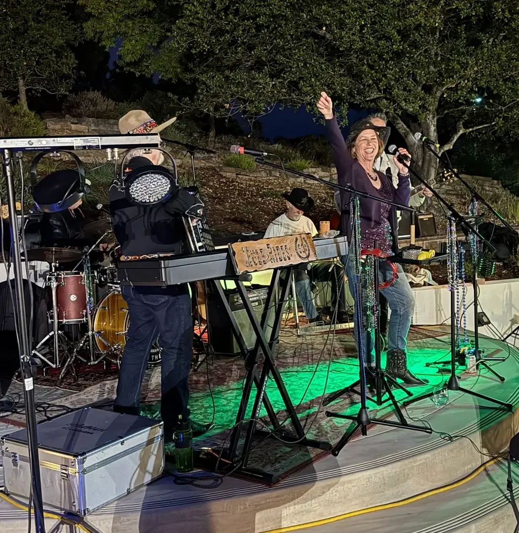 Outdoor band performance with enthusiastic singers.