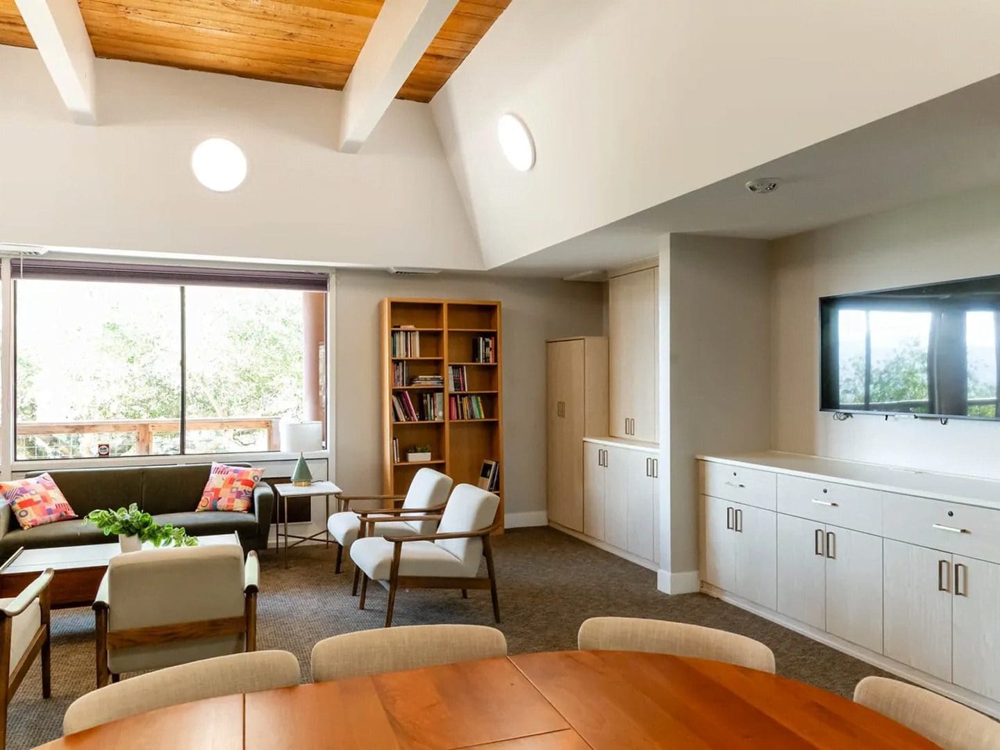 Modern living room with wooden ceiling beams.