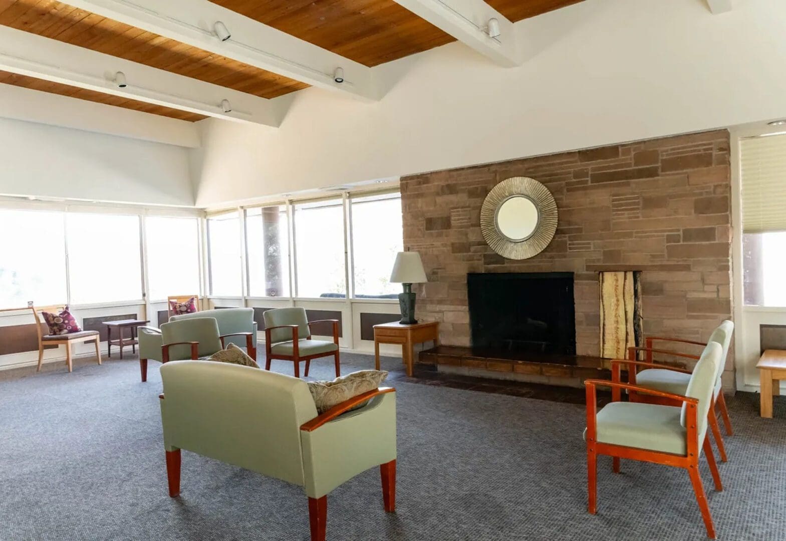 Spacious lounge with modern furniture and fireplace.