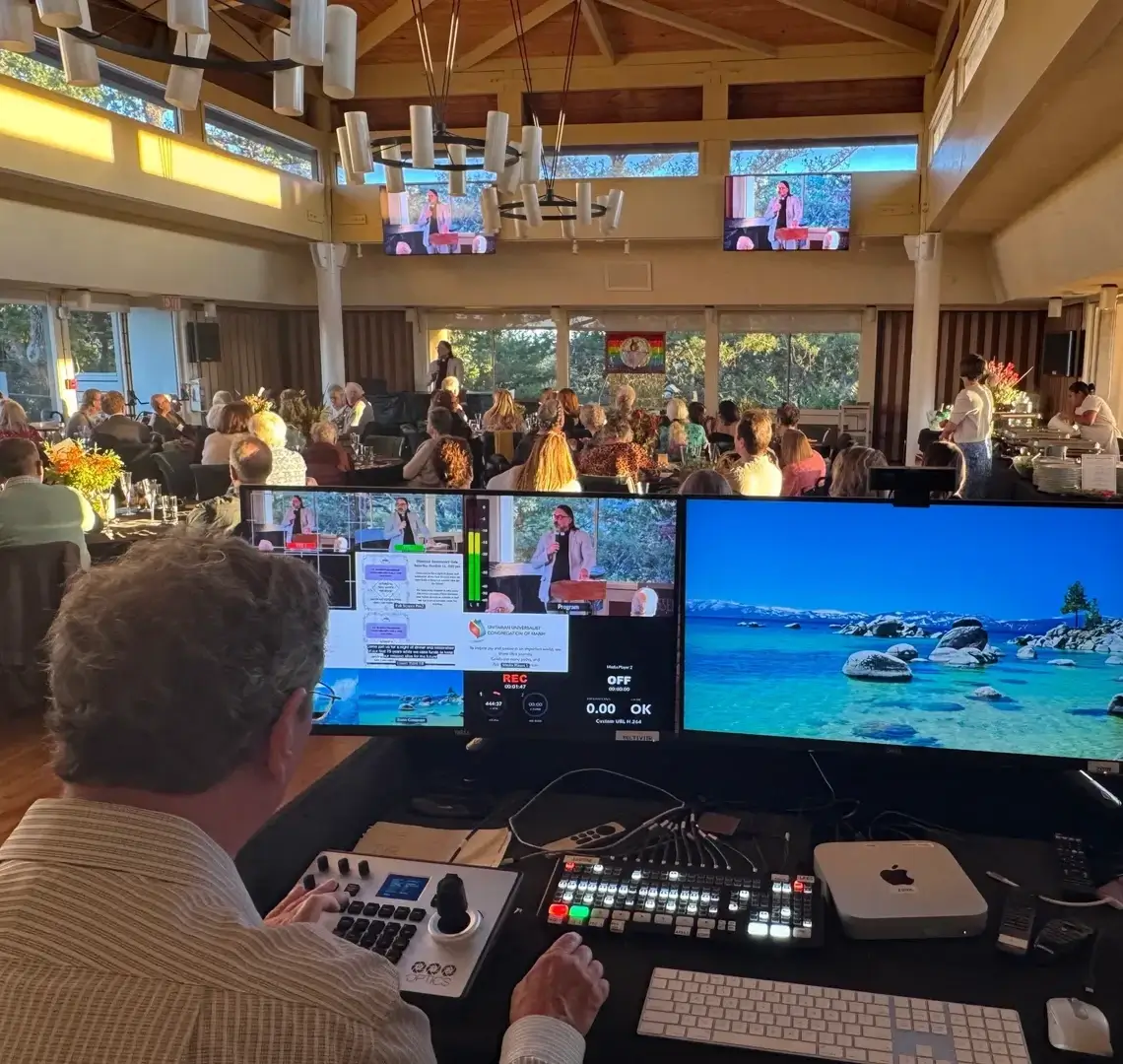 Event control room with audience and screens.