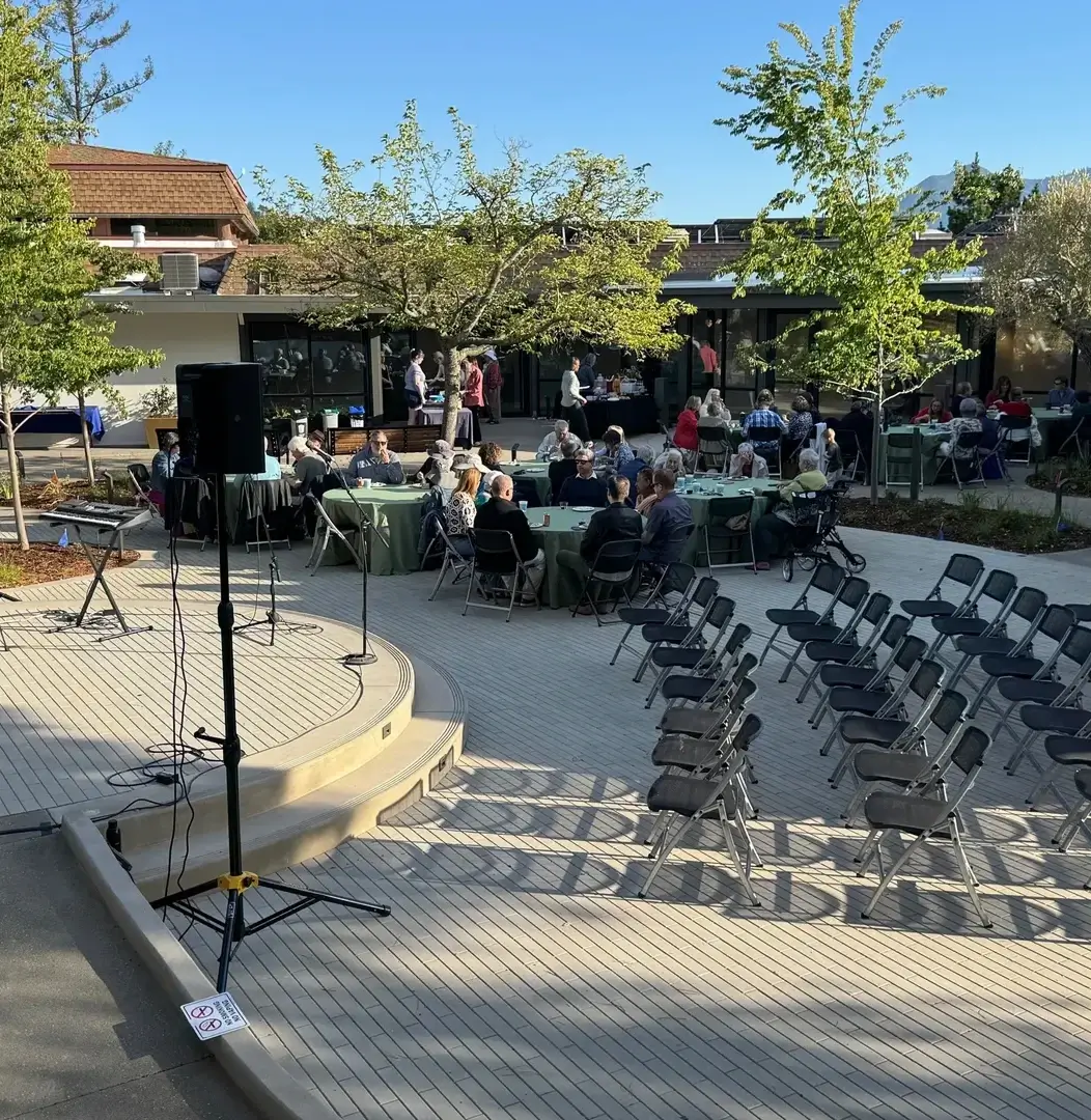 Outdoor event with tables and chairs setup.
