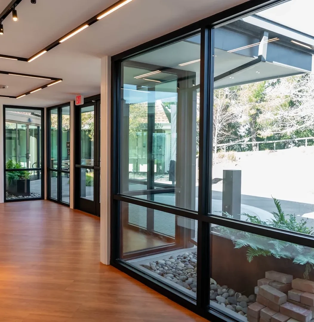 Modern hallway with large glass windows.