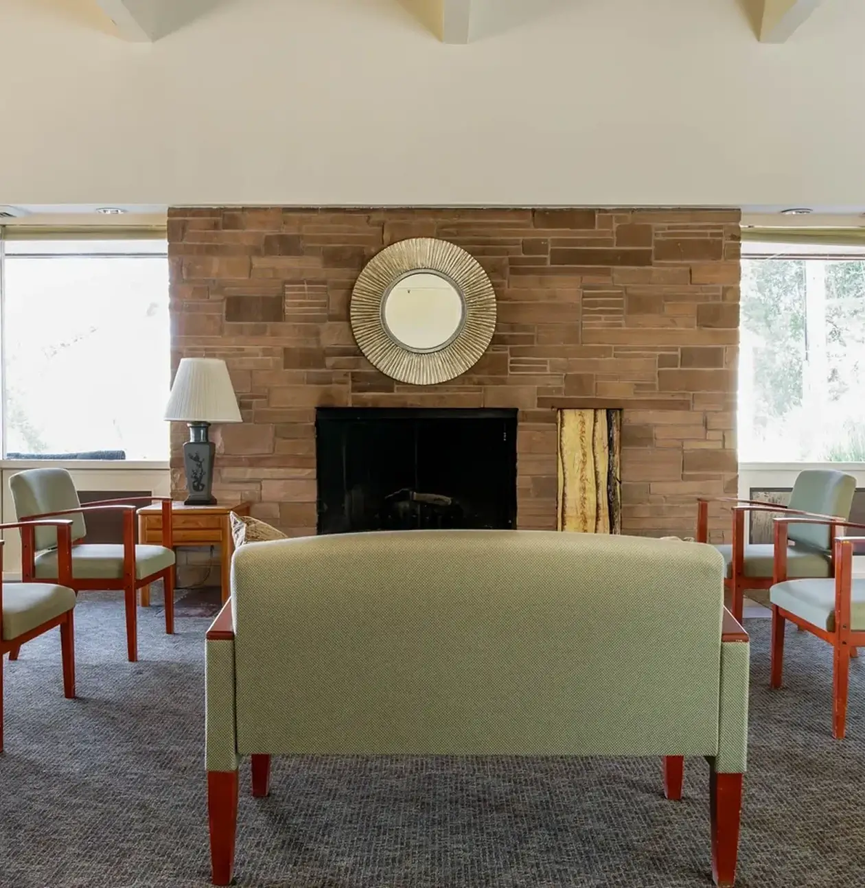 Living room with chairs and fireplace.