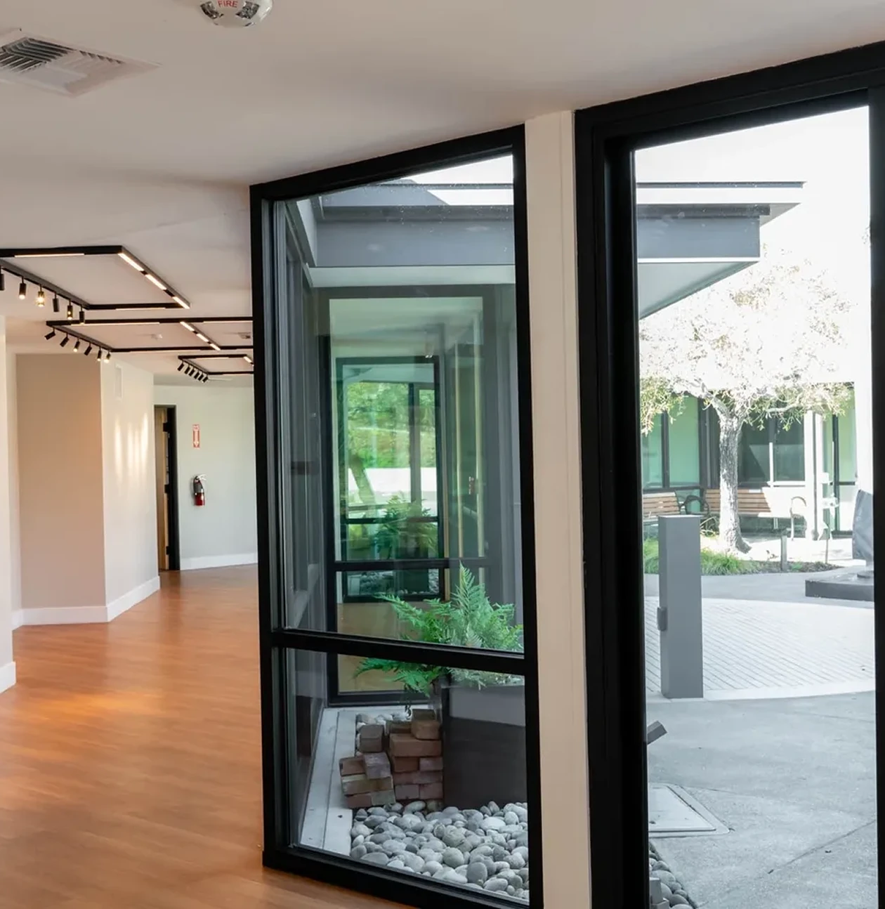 Modern hallway with large glass windows.