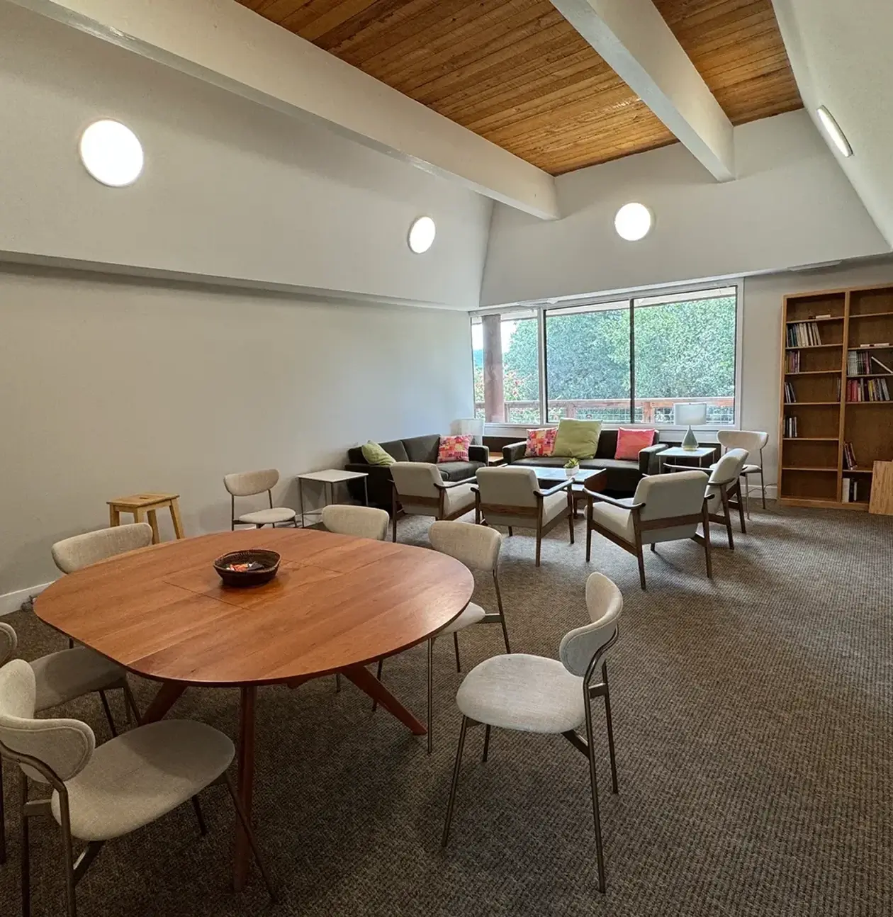 Modern meeting room with round table and chairs.