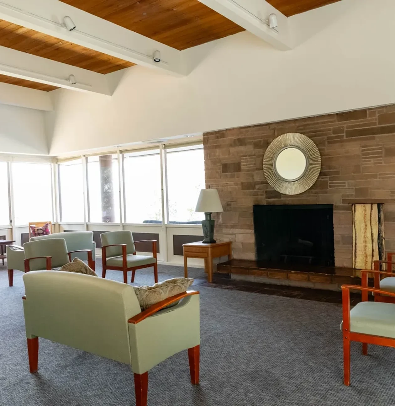 Modern living room with fireplace and chairs.