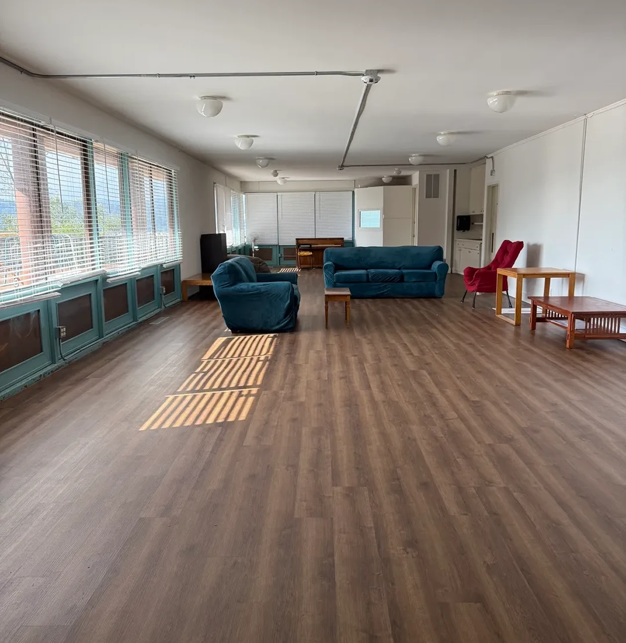 Spacious living room with blue sofas.